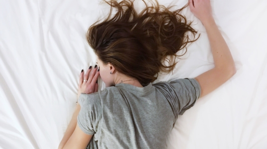 woman laying on bed