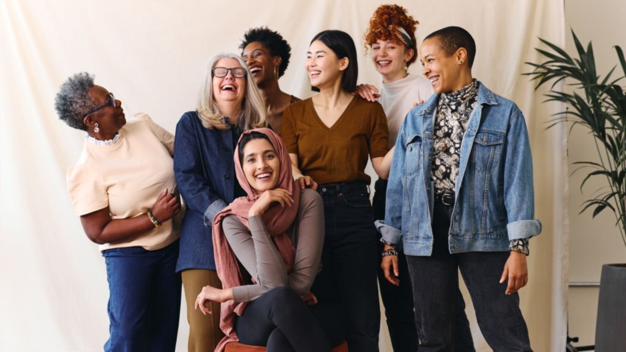 Portrait of cheerful mixed age range multi ethnic women celebrating International Women's Day